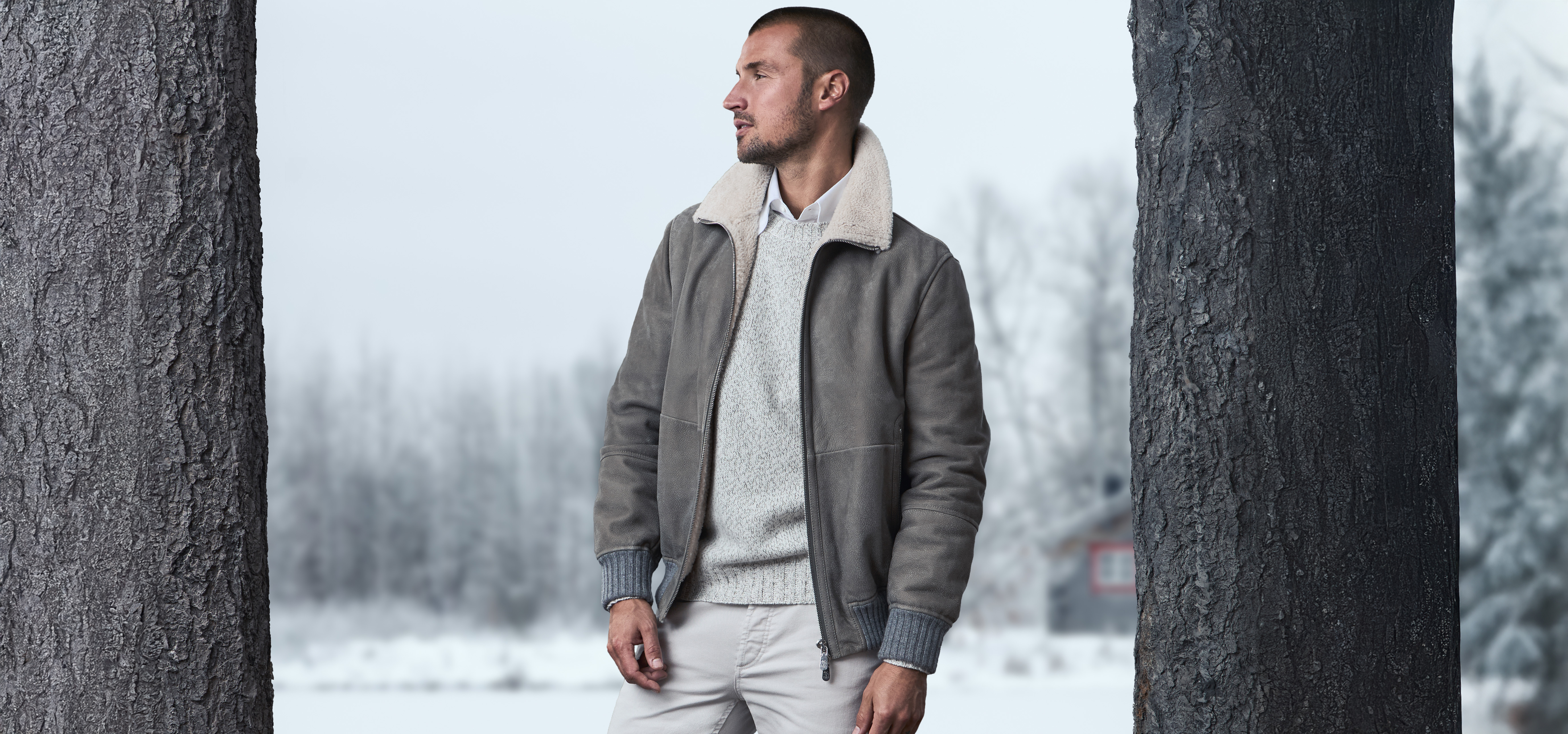 Male model wearing short winter jacket with sherpa collar